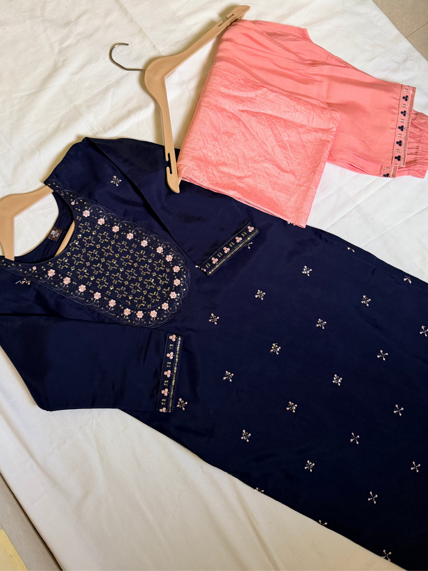 Navy blue embroidered top and pink pants