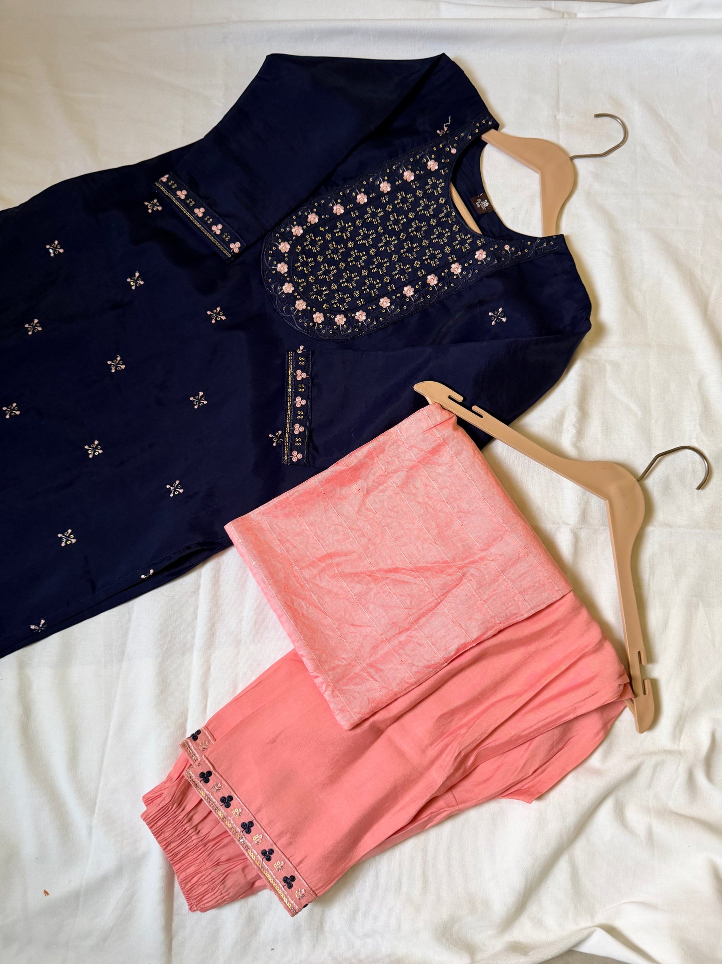 Navy blue embroidered top and pink pants