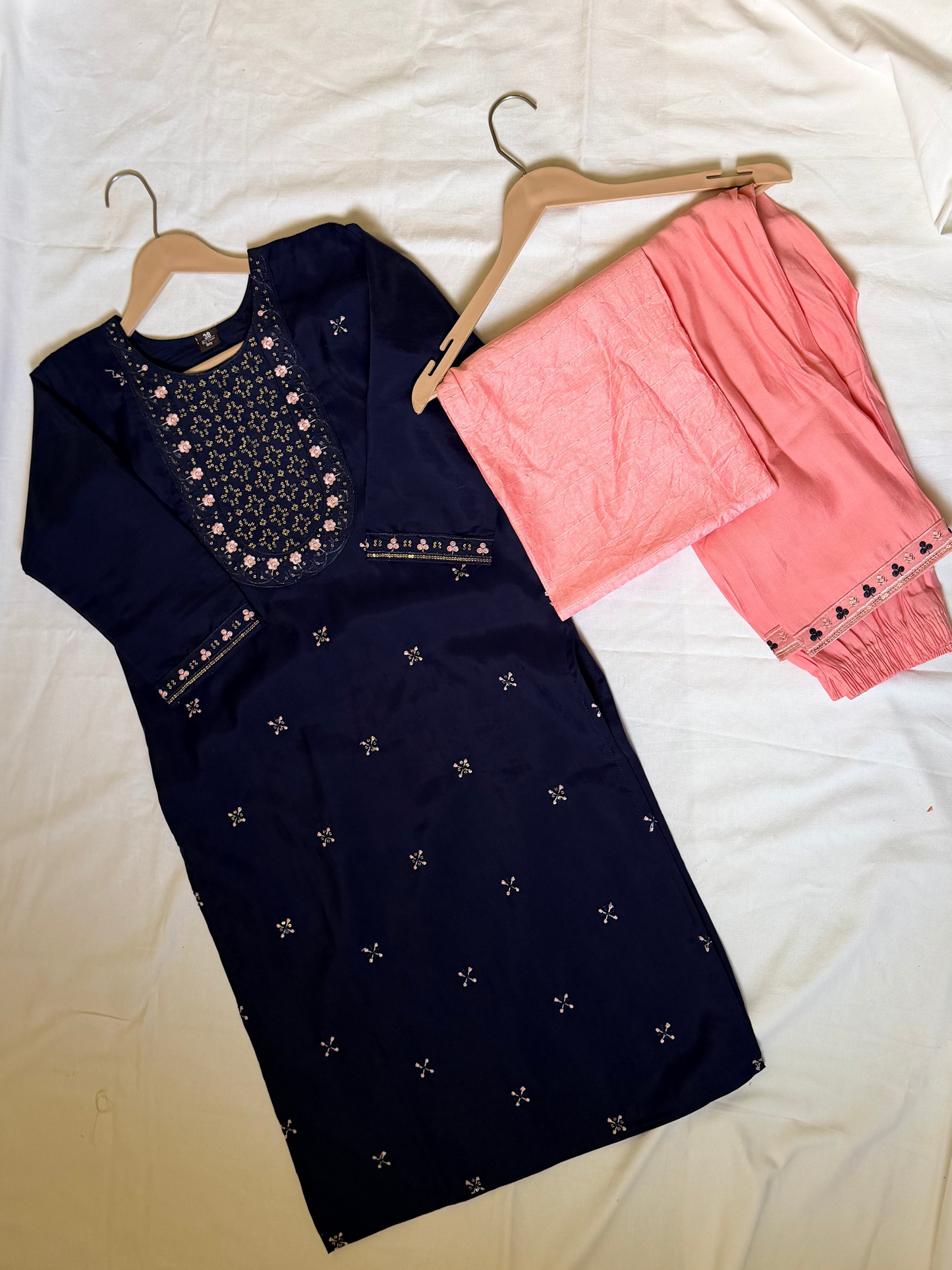 Navy blue embroidered top and pink pants