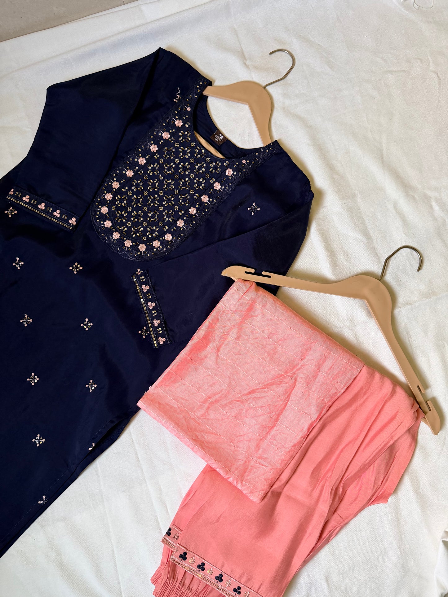 Navy blue embroidered top and pink pants