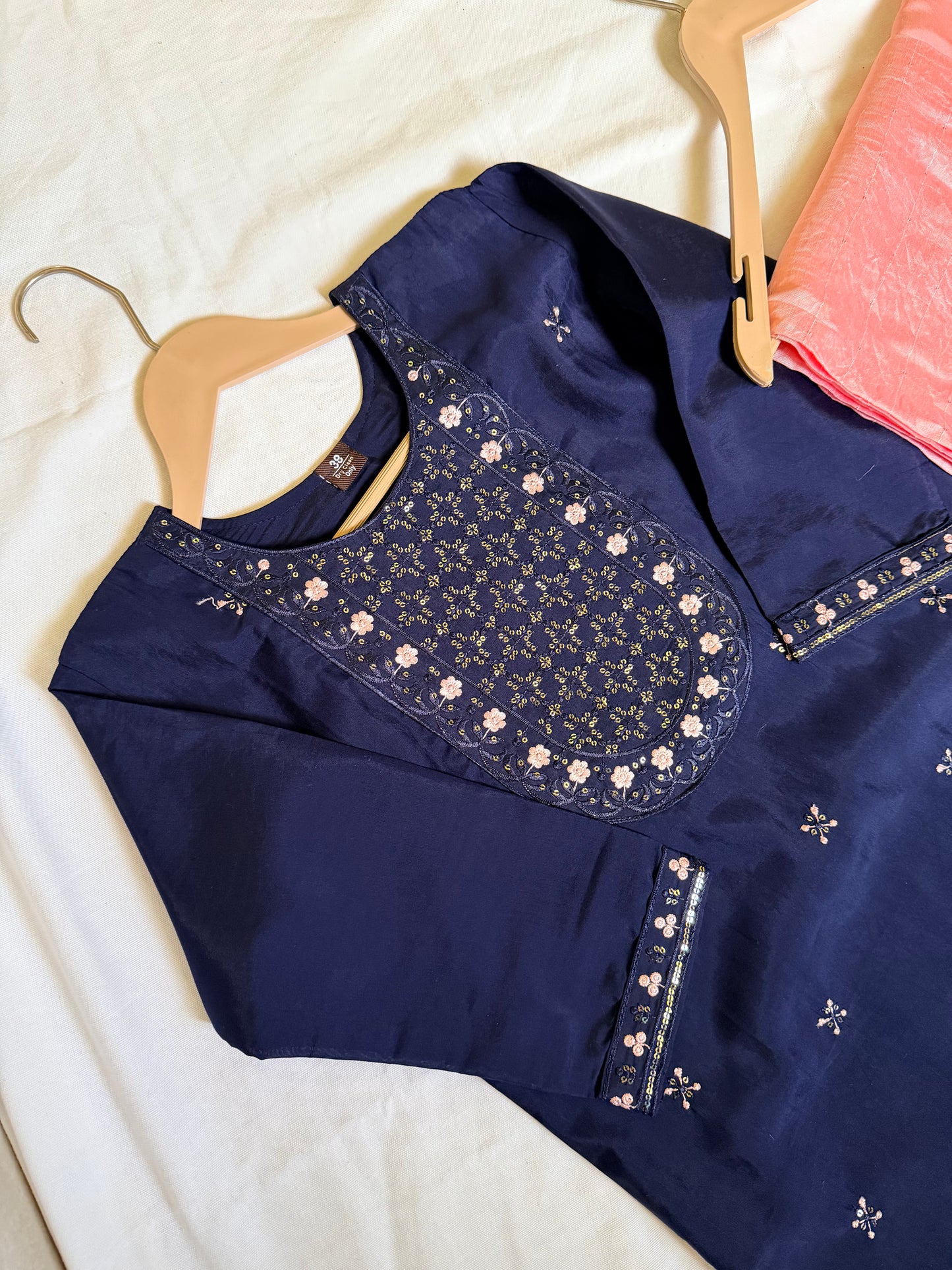 Navy blue embroidered top and pink pants